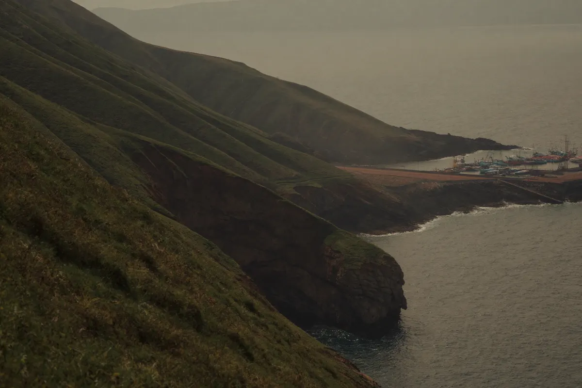 Côte basque : collines vertes tombant vers la mer et falaises en strates